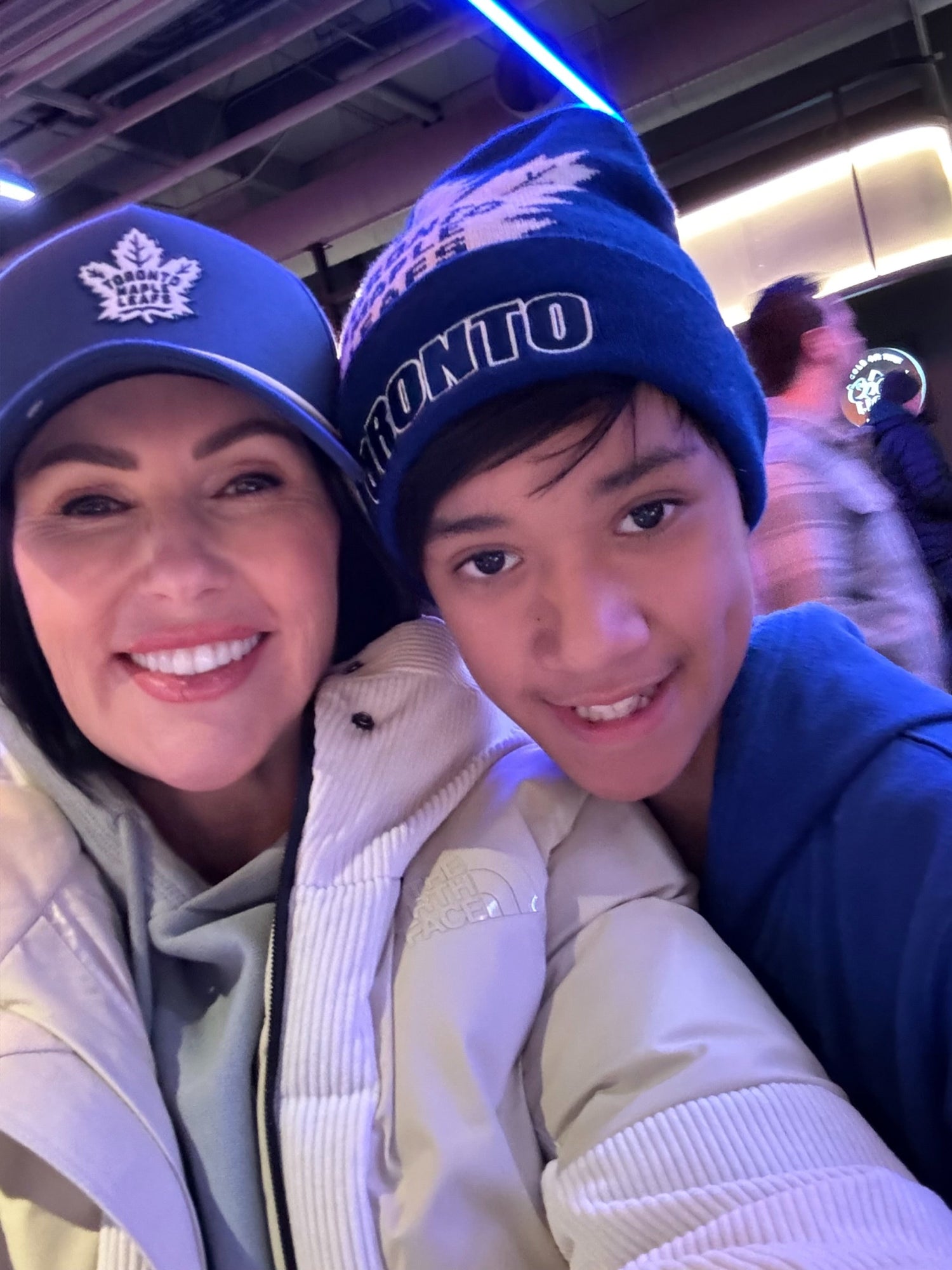 Penny Lane and son Elemein Cash at an ice hockey game in Canada